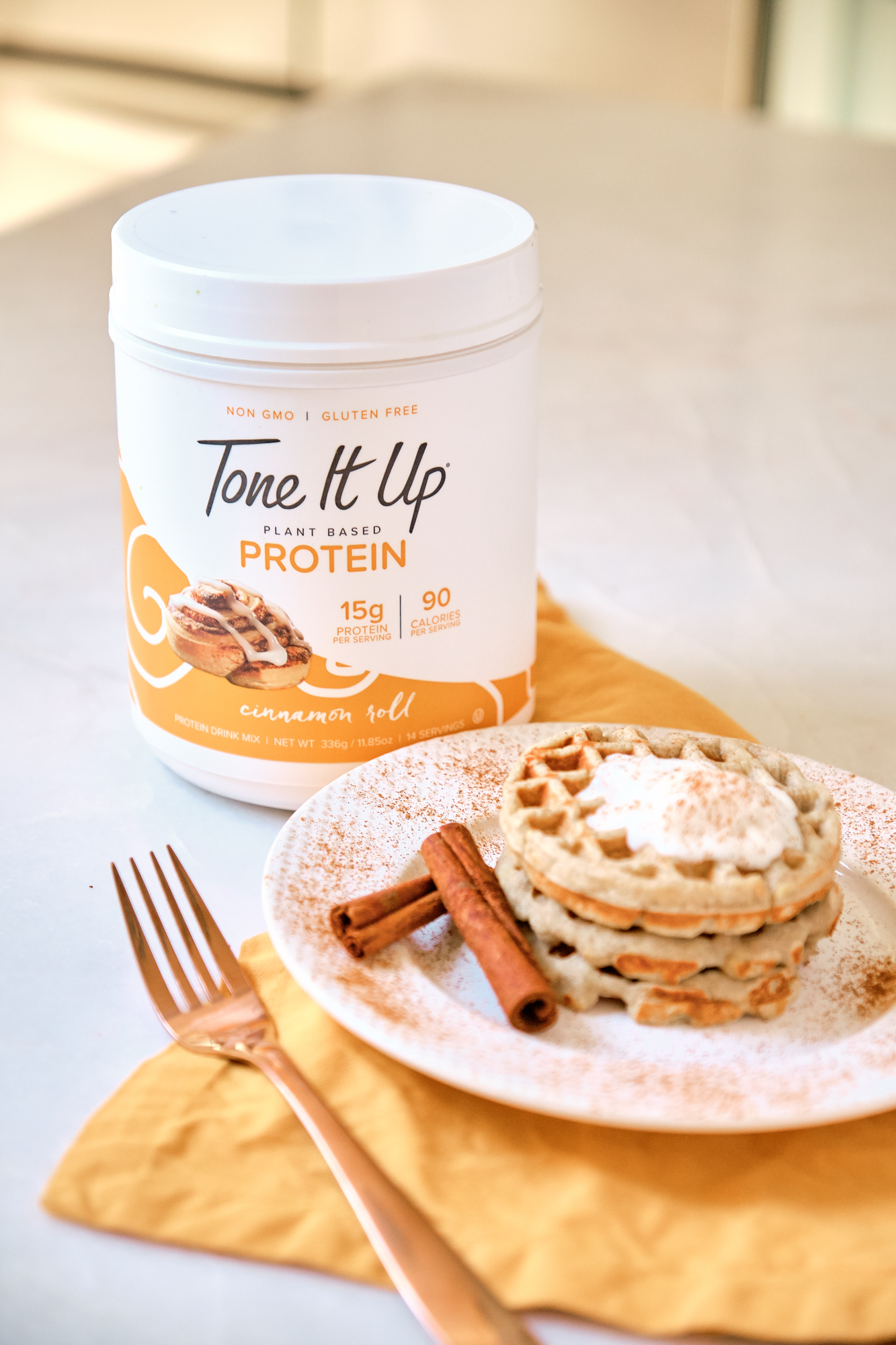 Tone It Up Cinnamon Roll Protein is clean, gluten free, and delicious. Try these easy protein waffles.